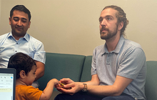 Mason Tuttle with Refugee Family